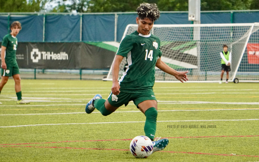 Soccer player getting ready to kick ball