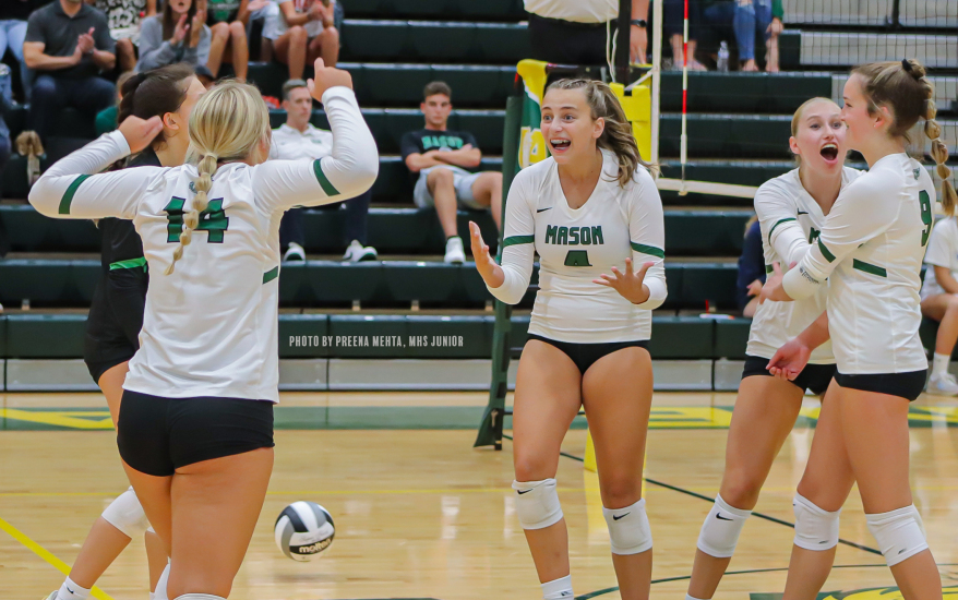 Girls celebrating at volleyball game