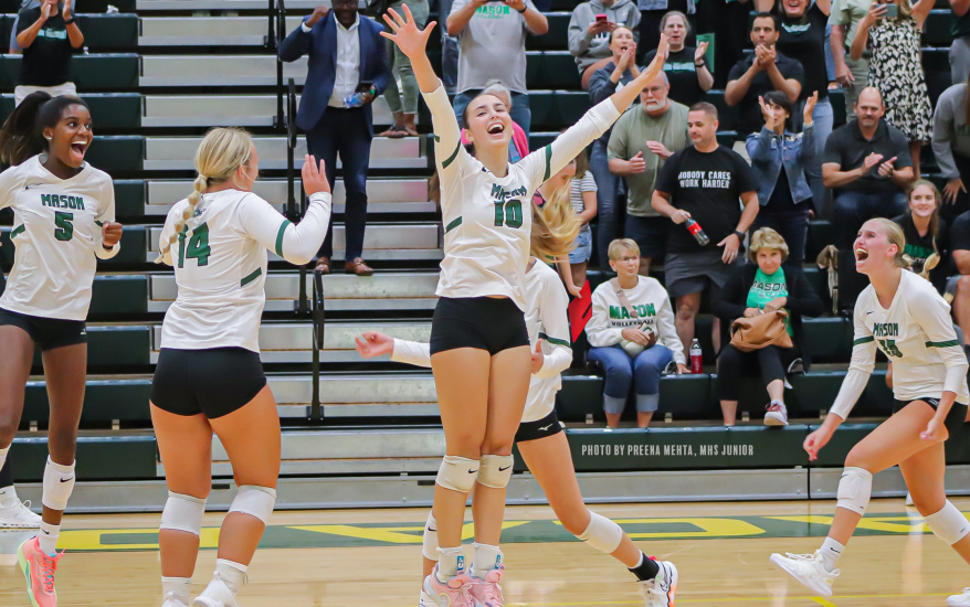 Girls celebrating at volleyball game