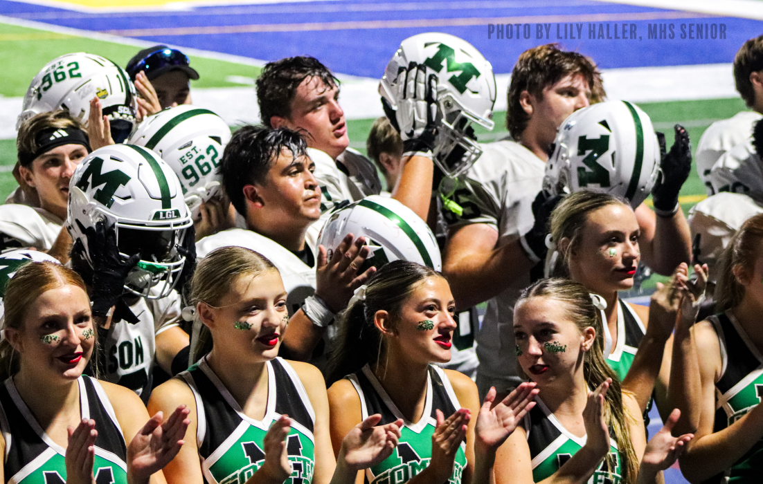 Football team and cheerleaders together