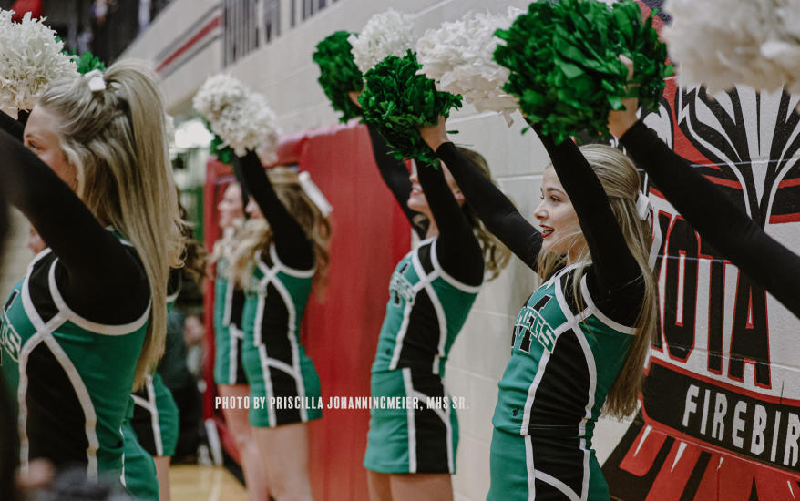 girls holding up pom poms