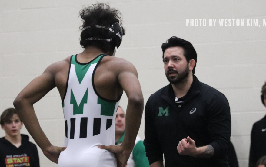 Coach coaching wrestler